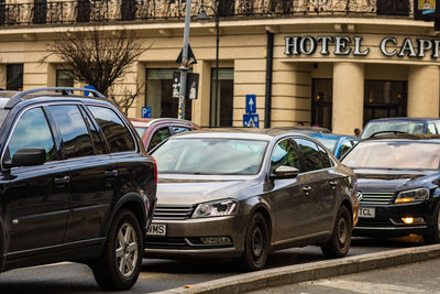 Cars parked on street against buildings in city