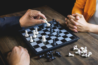 Business colleagues playing chess on table