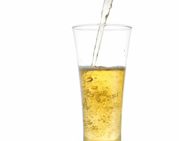 Close-up of beer glass against white background