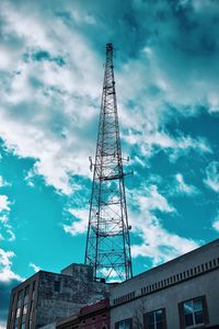 Low angle view of crane and building against sky