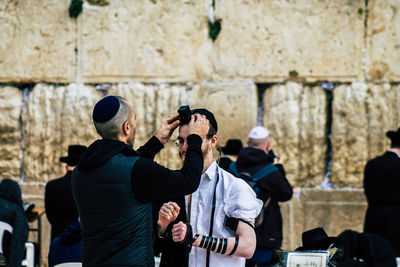 Rear view of people photographing