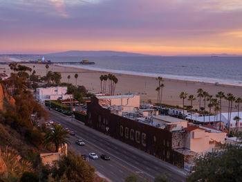 High angle view of road by sea against sky during sunset