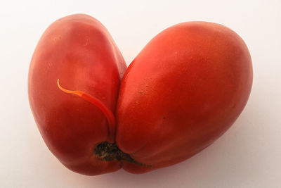 Close-up of red fruit on white background