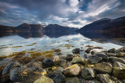 Scenic view of lake and mountains against sky