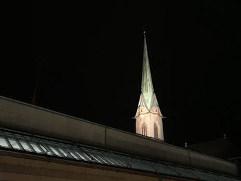 Low angle view of illuminated city against sky at night