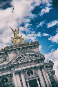 Low angle view of statue against cloudy sky