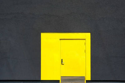 Full frame shot of yellow door and building