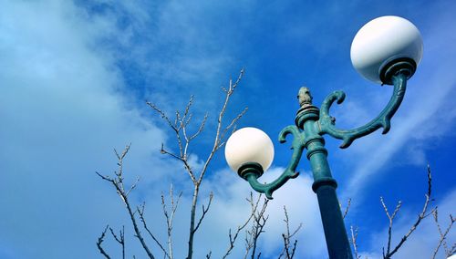 Low angle view of street light against blue sky