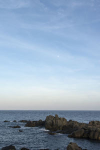 Scenic view of sea and rocks against sky