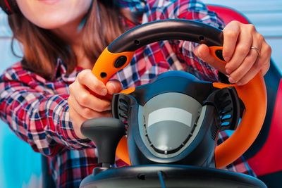 Close-up of woman holding steering wheel