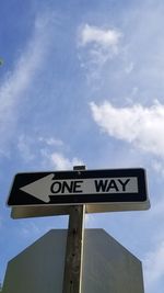 Low angle view of road sign against sky