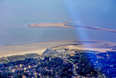 High angle view of sea and cityscape against sky