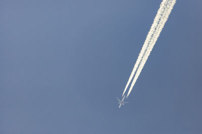 Low angle view of airplane flying in sky