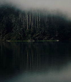 Scenic view of lake against sky at night