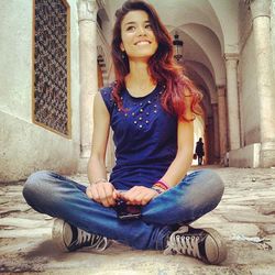 Portrait of a young woman sitting outdoors