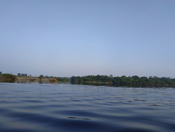 Surface level of lake against clear sky