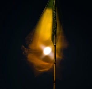 Low angle view of illuminated lamp against sky at night