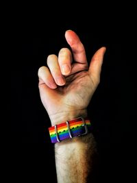 Close-up of person hand over black background