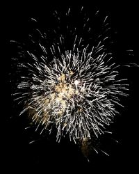 Low angle view of firework display at night