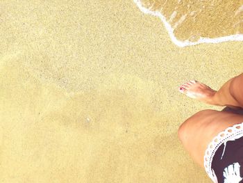 Low section of woman standing on beach