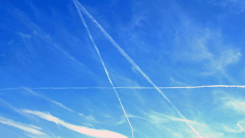 Low angle view of vapor trails in sky