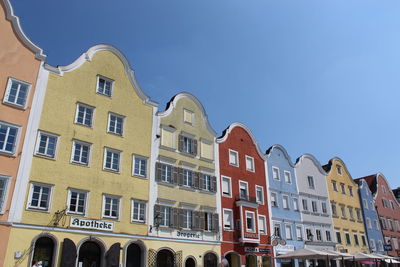 Low angle view of buildings against blue sky