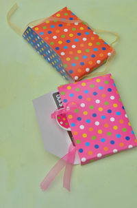 Close-up of colorful paper bags on table