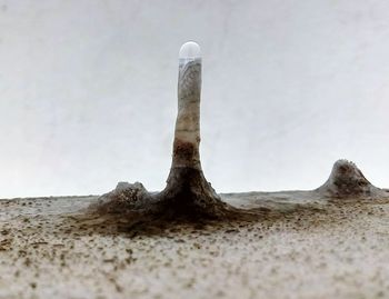 Close-up of sand against sky