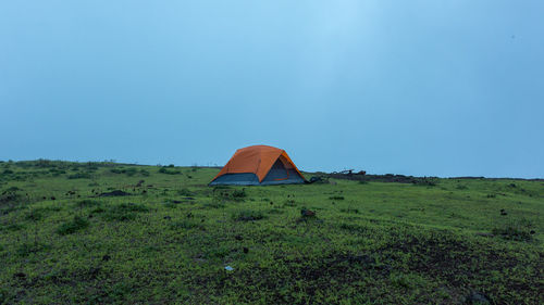 Tent on field against clear sky