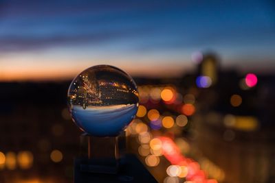 Close-up of crystal ball against sky at night