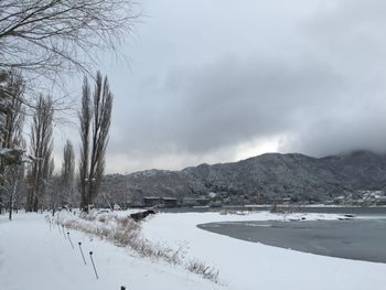 Scenic view of mountains against cloudy sky