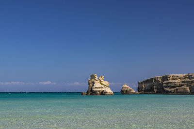 Scenic view of sea against clear blue sky