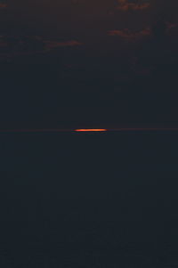 Vapor trails in sky at night