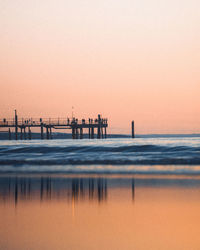 Scenic view of sea against clear sky during sunset