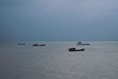 Boat sailing in sea against sky