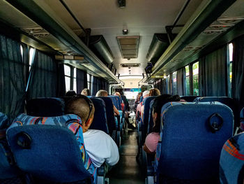 Rear view of people sitting in train