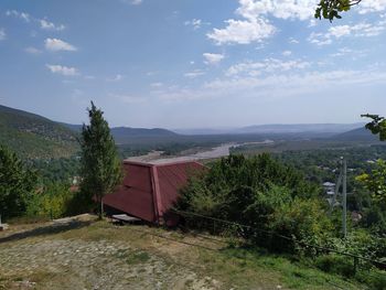Scenic view of trees and buildings against sky