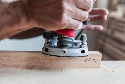 Close-up of man working on metal