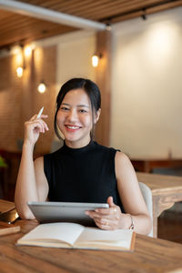 Young woman using laptop at table