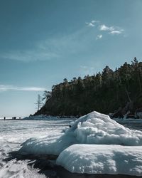 Scenic view of frozen lake against sky during winter