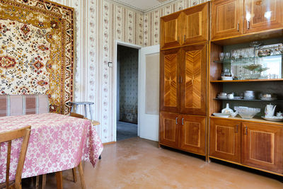 Old soviet  poor interior in khruschev house. aged sideboard.  shabby floor. tattered wallpaper. 