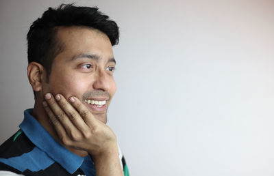 Portrait of young man against white background