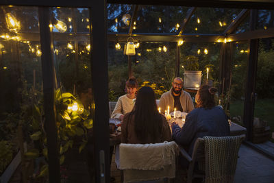 Friends having meal in greenhouse