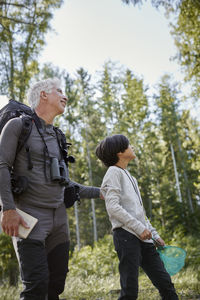 Rear view of couple kissing in forest