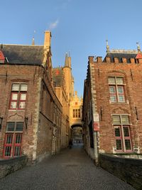 Alley amidst buildings against sky in city