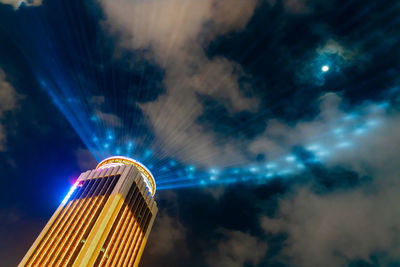 Low angle view of illuminated ferris wheel against sky at night