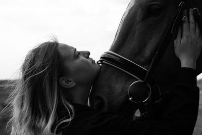 Girl and horse hug.