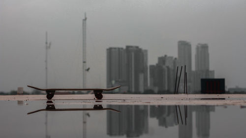 Tall buildings against sky with waterfront