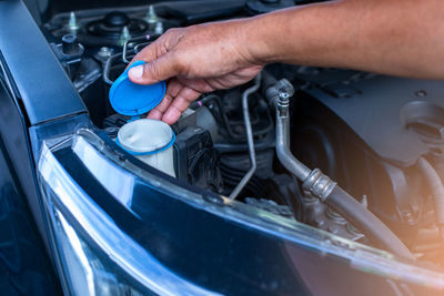 Cropped image of man repairing car