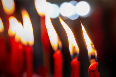 Close-up of lit candles in temple